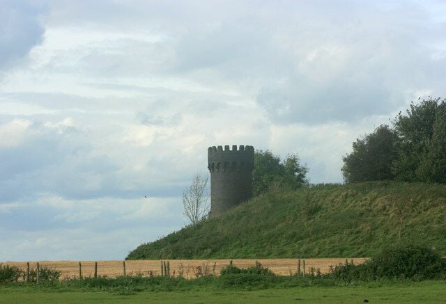 Castellated air shaft, Old Sodbury. Awake! for Morning in the Bowl of Night Has flung the Stone that puts the Stars to Flight: And Lo! the Hunter of the East has caught The Sultan's Turret in a Noose of Light. In fact it is not a Sultan's Turret it is the first air shaft from the west of the Old Sodbury railway tunnel. There is also a mound of spoil dug from the tunnel, and it is 4 o'clock in the afternoon. 364896 shows the same object from a different direction. The quotation from Omar Kayyam was copied from http://en.wikisource.org/wiki/The_Rubaiyat_of_Omar_Khayyam/First_Edition