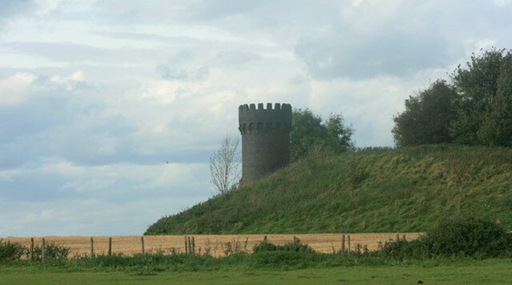 Castellated air shaft, Old Sodbury. Awake! for Morning in the Bowl of Night Has flung the Stone that puts the Stars to Flight: And Lo! the Hunter of the East has caught The Sultan's Turret in a Noose of Light. In fact it is not a Sultan's Turret it is the first air shaft from the west of the Old Sodbury railway tunnel. There is also a mound of spoil dug from the tunnel, and it is 4 o'clock in the afternoon. 364896 shows the same object from a different direction. The quotation from Omar Kayyam was copied from http://en.wikisource.org/wiki/The_Rubaiyat_of_Omar_Khayyam/First_Edition