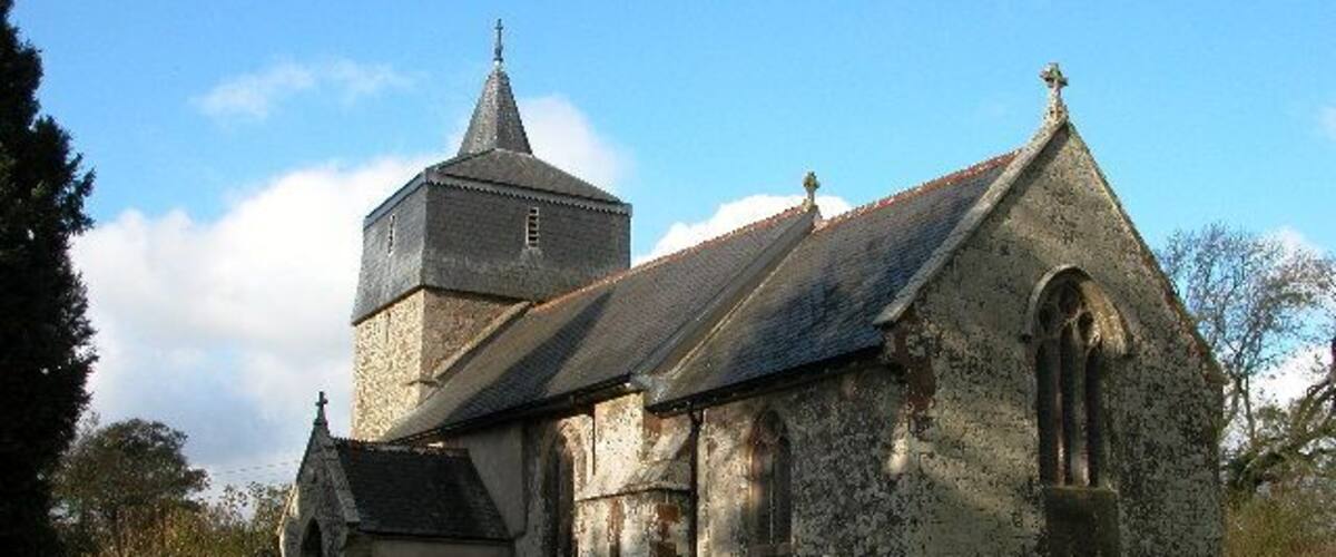 Parish church of St Mary the Virgin, Brushford, Devon, seen from the southeast. The bell stage of the west tower is timber framed and hung with slate.