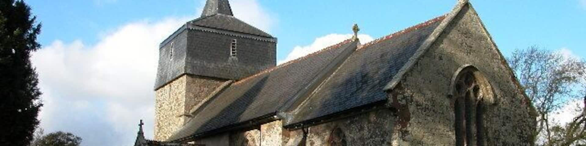 Parish church of St Mary the Virgin, Brushford, Devon, seen from the southeast. The bell stage of the west tower is timber framed and hung with slate.