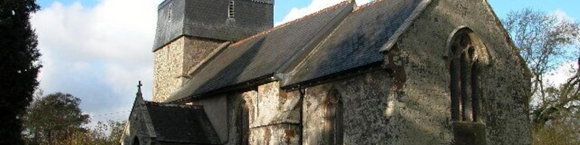 Parish church of St Mary the Virgin, Brushford, Devon, seen from the southeast. The bell stage of the west tower is timber framed and hung with slate.