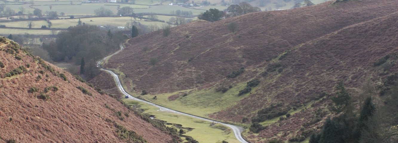 Valley below Gogbatch near Womerton View from an outcrop above Gogbatch with Caer Caradoc Hill in background.