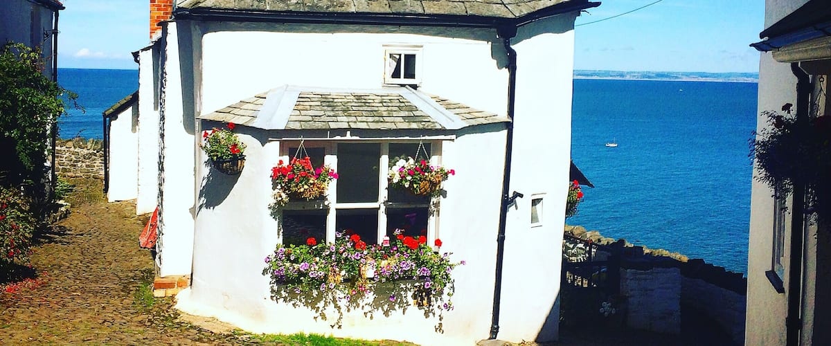 Clovelly in Devon UK. One of the most picturesque places on the planet! No cars allowed, residents must park at the top if the village & pull everything up on a sledge!