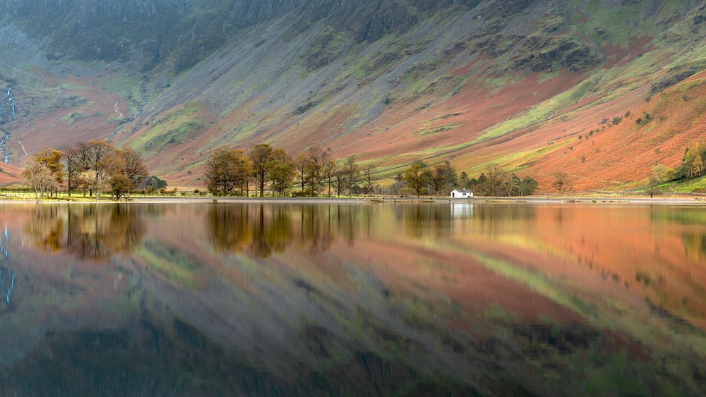 Buttermere panorama with perfect reflections taken on a calm Autumn morning in the Lake District, UK.