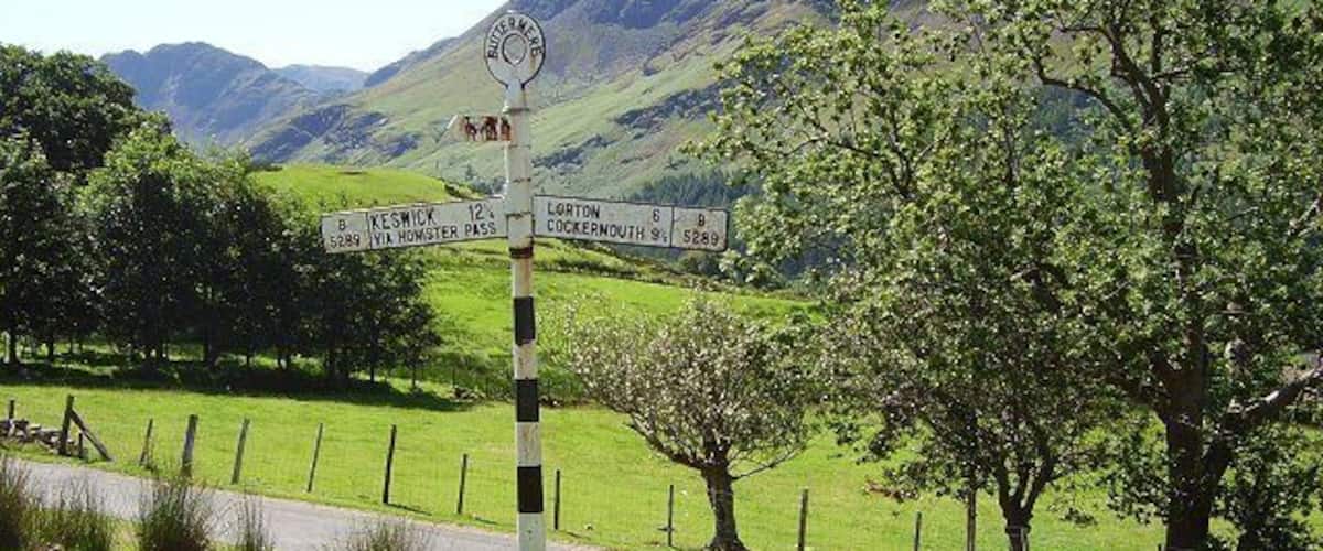 Signpost, Buttermere Old cast iron Cumberland C.C. signpost. When erected, the two passes out of the village must have been formidable obstacles. Now all three roads are hard going because of the volume of traffic. (All but the foreground and signpost are in another square.)