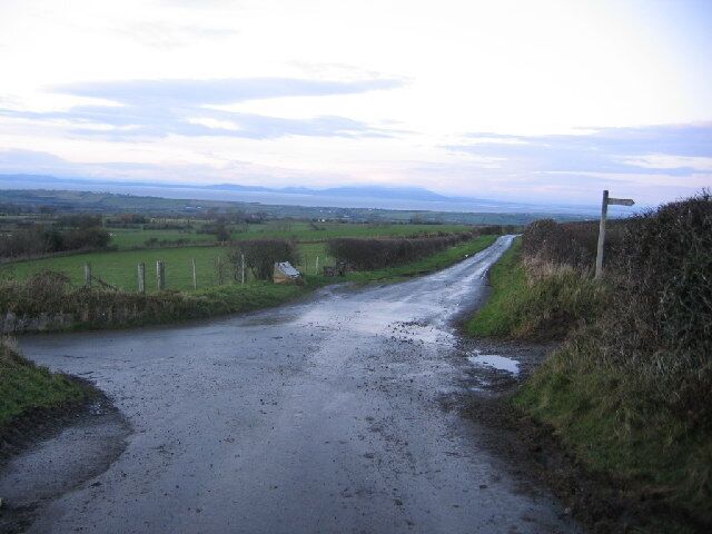 Crossroads and Scotland. The crossroads are the feature and the footpath stands out well but that is Scotland across the Solway in the background.