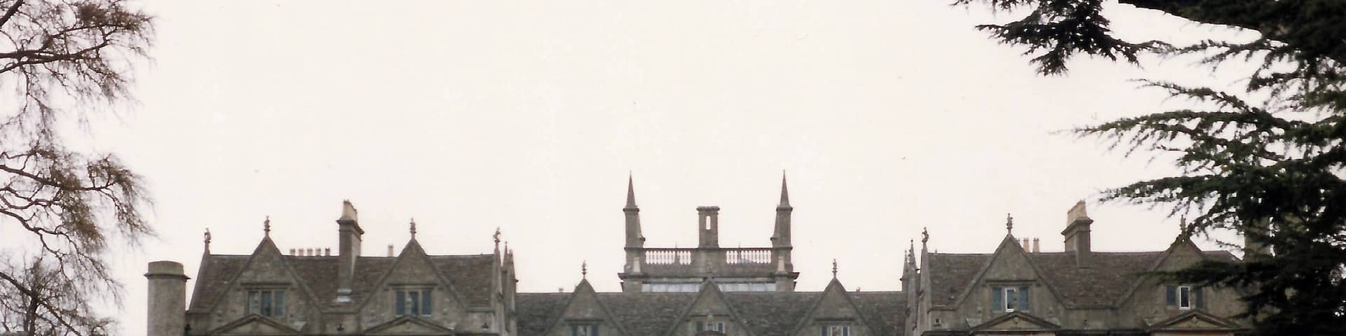 A large, historic building with a symmetrical facade, large windows, and a central entrance.
