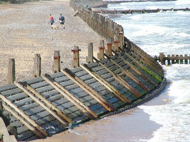 A beach with a wooden groyne structure.