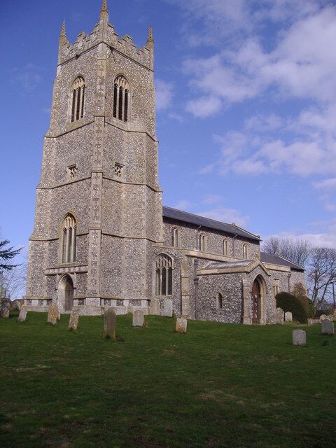 A stone church with a tall tower and arched windows.