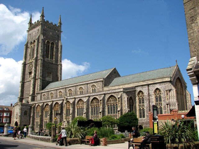 A large Gothic-style church with a tall tower and arched windows.