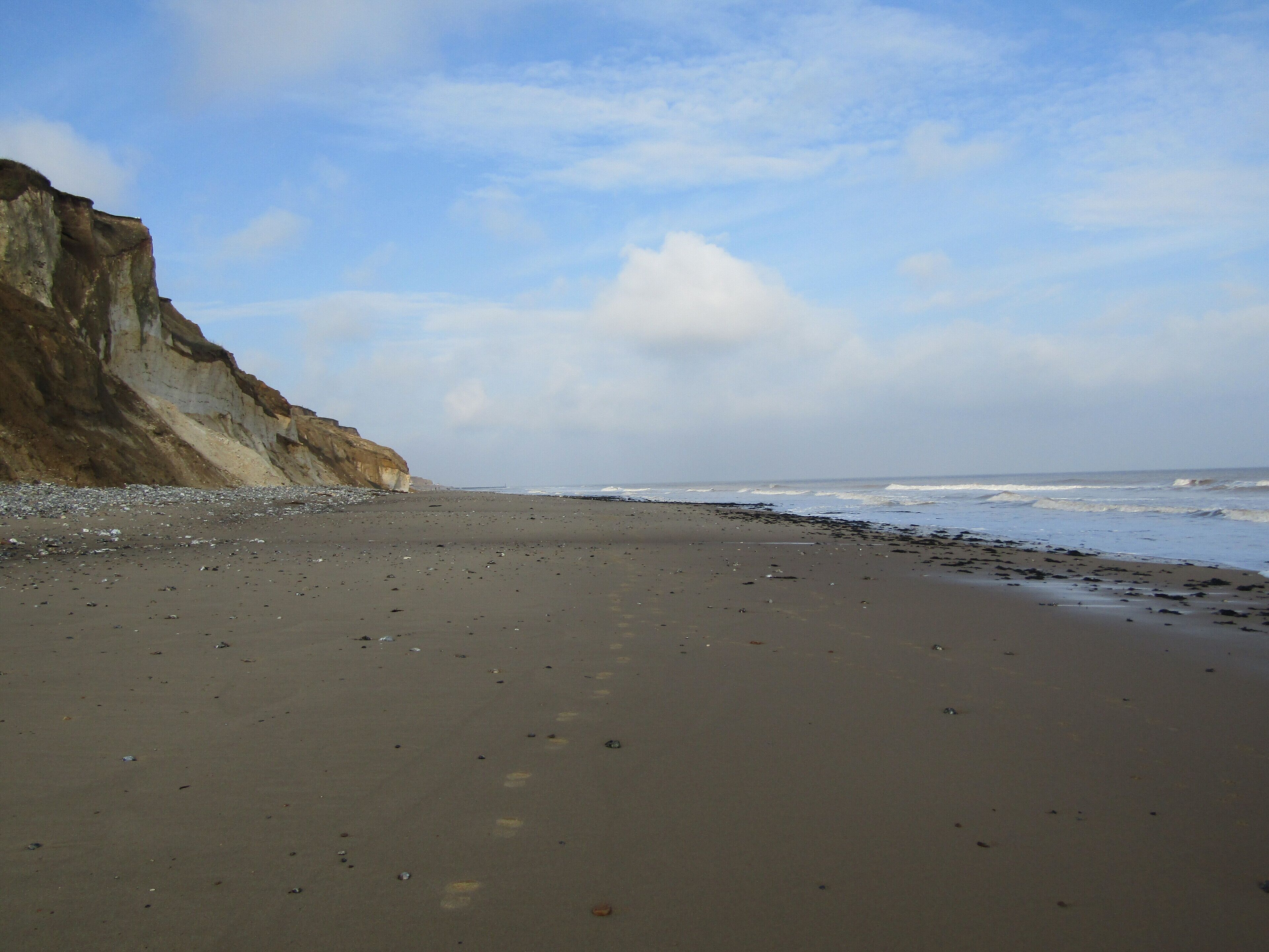 Looking west towards West Runton along East Runton Beach in the village of East Runton, Norfolk, England.