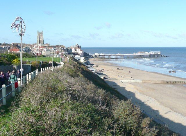 A coastal town with a beach, a pier, and a church.