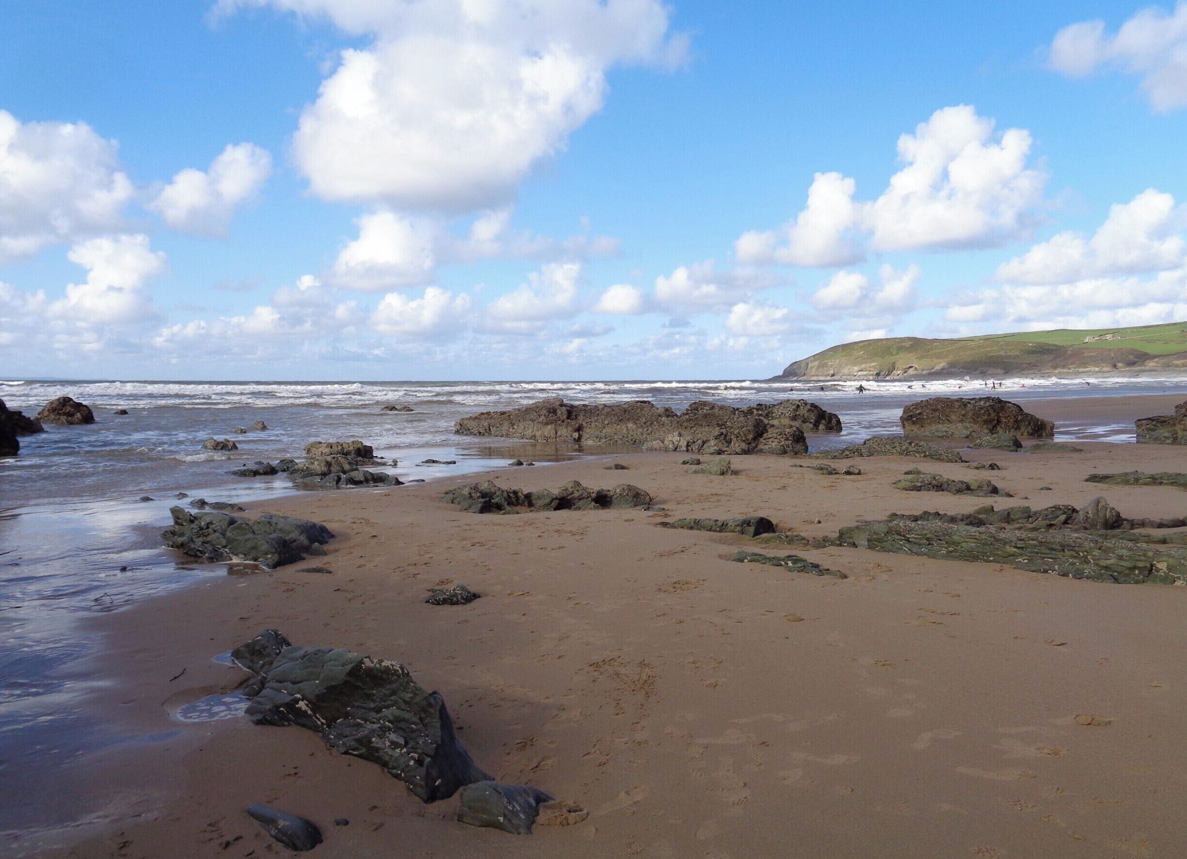 Extraordinary rock formations surrounding a vast sandy beach extremely popular with surfers.
