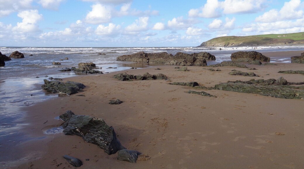 Extraordinary rock formations surrounding a vast sandy beach extremely popular with surfers.
