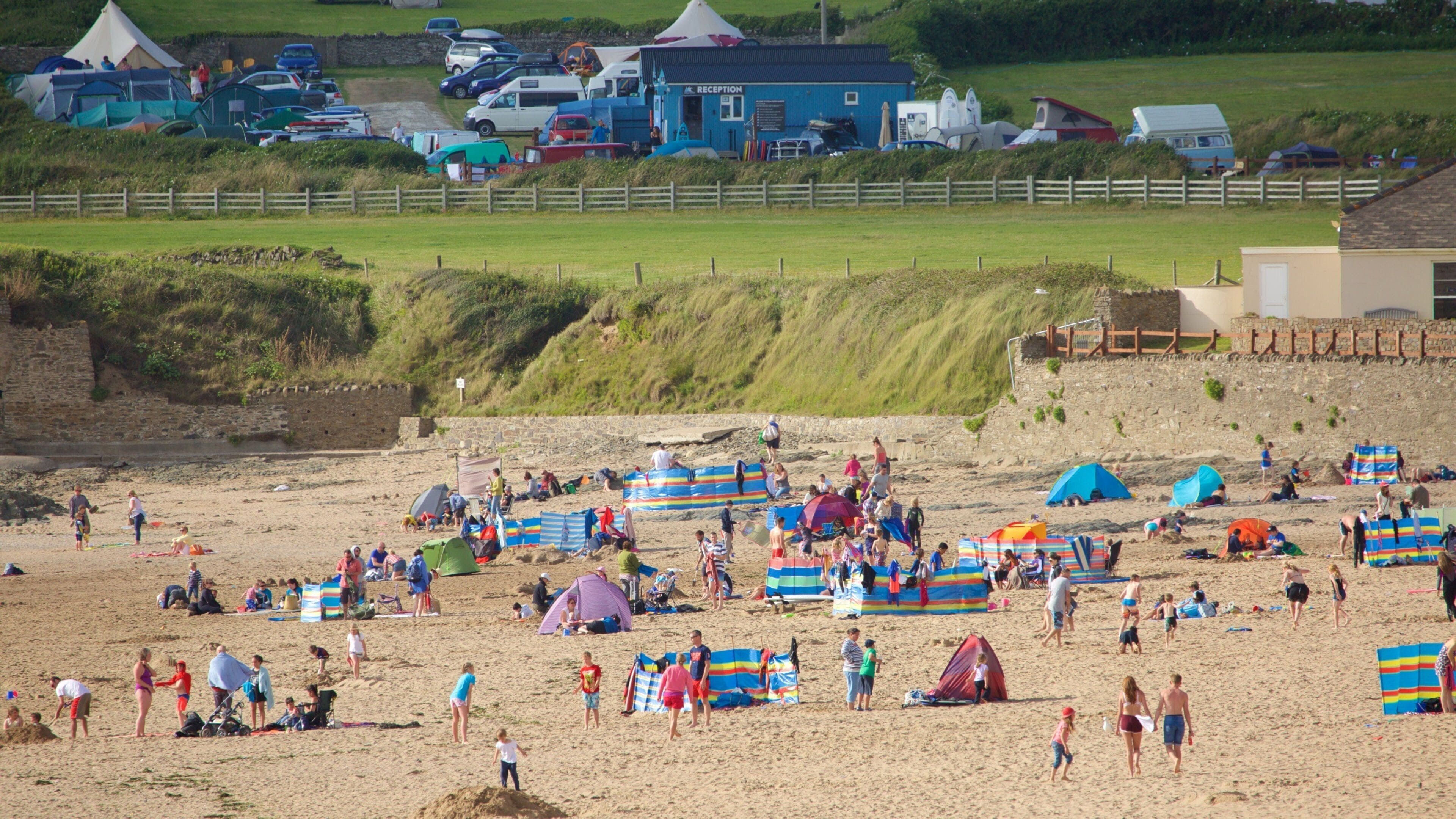 Croyde which includes a beach as well as a large group of people