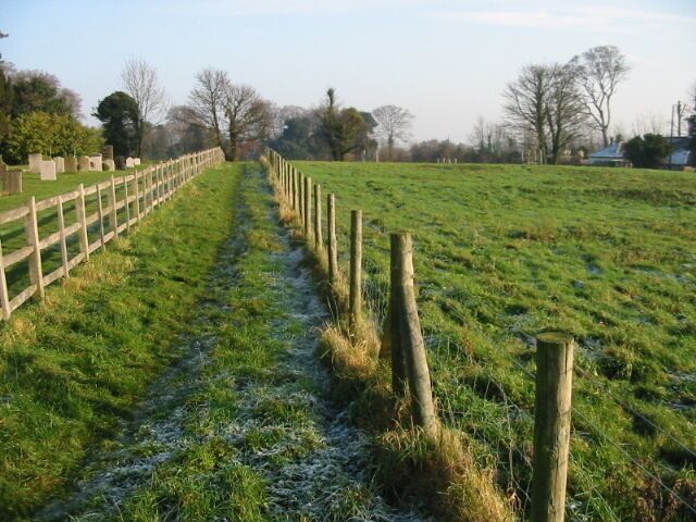 Path towards Church Lane The path runs alongside the churchyard.