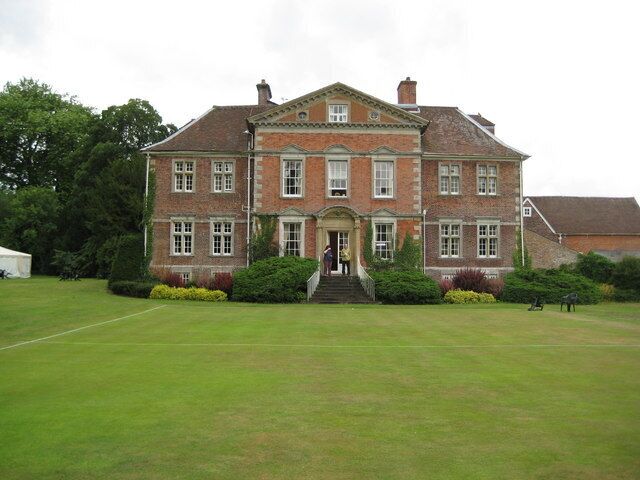 Urchfont Manor (2). This is the east façade of the manor house, whose history is briefly told here 1403212 This side of the building, although built only about nine years after the original house, is markedly different, its seven bays with a pediment over the three central ones in the then very modern Wren or Queen Anne style being designed to create the impression that the house was much larger than it really was. The rear of the north end of this extension can be seen in the other image and demonstres the difference between the two parts of the building. The manicured lawn in front is a croquet pitch.