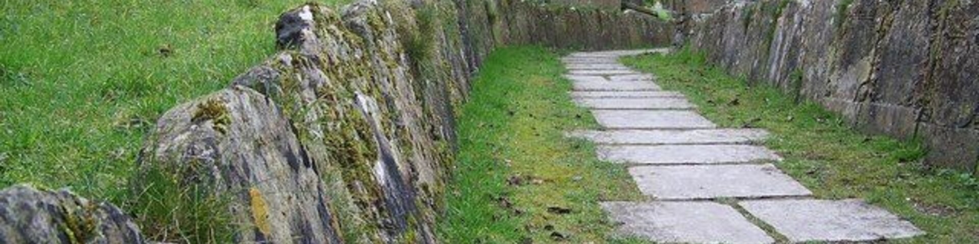 Gravestones at St Peter's Church, Great Cheverell Ancient gravestones line the path to the church porch.