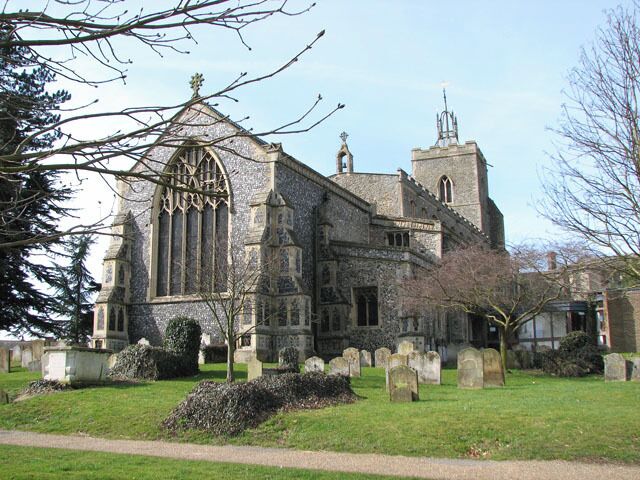 The church of St Mary in Diss. St Mary's Church > 1768170 is situated above Mere Street and the Market Place. The building has a tower with open arches underneath - this ensured that processions around the church, as was customary in medieval times, could pass through and remain within the church precincts. Built from local flint and limestone from Normandy, St Mary's church was started in 1290, with two side chapels added between 1430 and 1440. The west window in the south chapel contains medieval stained glass > 1768959 but all other windows are reconstructions > 1768945 of earlier ones and date from between 1866 and 1882. The east window > 1768909 is by Francis W Oliphant and was installed around 1857 when the chancel was extended and the small square window was replaced by the present one. The baptismal font > 1768971 was made in 1857.