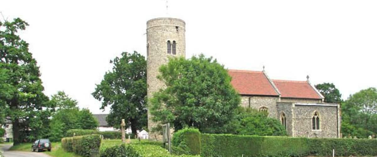 St Mary's church viewed from Burston Road. St Mary's church > 1366828 - 1366845 has a round tower which dates from the 10th or 11th century, with the two light windows with characteristic zig-zag carving were added in Norman times. Both south and north doorways > 1366822 have Norman zig-zag decorations also, as has the tower arch > 1367242. It is believed that the nave dates at least in part from Saxon times. The south chapel was added in the 13th century. The 14th century north chapel > 1366835 used to be the chapel of the Kemp family, lords of the manor from 1324 until the early 20th century - the many memorials on its walls are to family members > 1366838. The north porch is a C15 addition. St Mary's has a magnificent 15th century hammerbeam roof with rows of angels attached to it. The octagonal font > 748803 is 14th century. The church was extensively restored in Victorian times and the furnishings date from this time, although some of the original bench ends have been retained. St Mary's church is open every day.