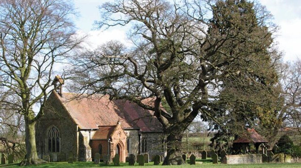 St Andrew's church in Thelveton This view was taken from Boudica's Way. Boudica's Way leads past the churchyard of St Andrew's church in Thelveton: coming from Norwich Road it crosses Church Road, passing the Grange and following Burston Road westwards until it turns off, leading across fields, to Frenze Hall, and to Diss from there. Boudica's Way is a 40-mile footpath that links Norwich and the market town of Diss on the Suffolk borders. The name Boudica (often spelled 'Boadicea', which was the Victorian version or 'Boudicca', used by Tacitus) derives from the Celtic 'bouda' which means victory. Boudica was the wife of the Icenian king Prasutagus. When he died his kingdom was annexed by the Romans, Boudica was flogged and her daughters raped. In AD 60 or 61 Boudica led the Iceni, along with others, in revolt. They destroyed Camulodunum (Colchester) and the site of a temple to the former emperor Claudius. Boudica was defeated in the end and is reported by Tacitus to have poisoned herself. The site where she is buried is unknown. St Andrew's church > https://www.geograph.org.uk/photo/1764785 is situated at a picturesque spot of the Thelveton Estate, bordered by fields and a cattle pasture. Boudica's Way long distance footpath > https://www.geograph.org.uk/photo/1764759 leads past the churchyard. The building - an estate church rather than a parish church - is of Norman origins but has been extensively restored by the Mann family, Lords of the Manor, from the late 1800s onwards. The tower collapsed in 1757 and has not been replaced, the furnishings date from the C19 restoration and the marble reredos > https://www.geograph.org.uk/photo/1764847 with mosaic inlay dates from that time. The chancel also houses a wall memorial to Thomas Mann (1886) > https://www.geograph.org.uk/photo/1764859 which was made by C Stoatt. The Mann family owns the estate to this day. The east window > https://www.geograph.org.uk/photo/1764855 was presented in 1899 in memory of Thomas Mann and his wife. The stained glass windows > https://www.geograph.org.uk/photo/1764864 are of very good quality, unfortunately noboby could tell me who made them. The octagonal font > https://www.geograph.org.uk/photo/1764872 is C15 and a large royal arms for Charles I (1620s) > https://www.geograph.org.uk/photo/1764874 hangs above the south doorway.