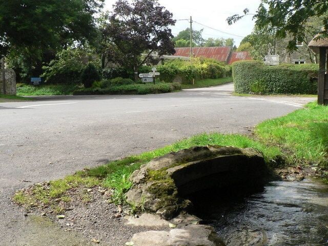 Litton Cheney: tiny stream under road The road is carried over a bridge across a small stream in the centre of the village.