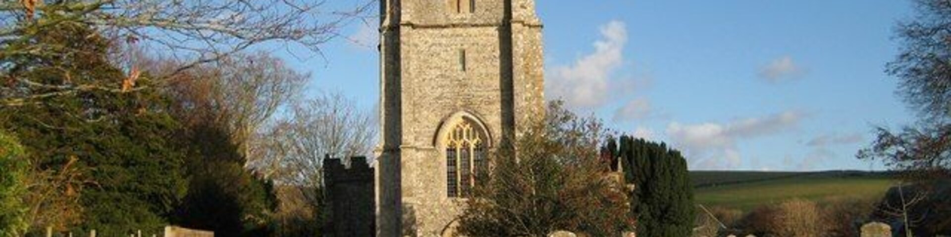 The churchyard - Sydling St Nicholas Looking across the spacious churchyard towards the Church of St Nicholas. Judging by the map the west side of the tower is within this gridsquare!