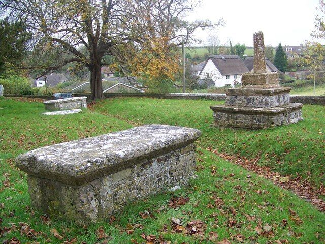 Churchyard, St Martin's Church, Cheselbourne Near the porch is the ramins of a 15th century cross and a table tomb which was used as a 'dole table'.