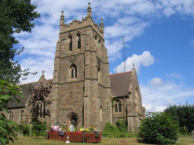 A historic church with a tall tower and arched windows.