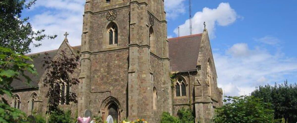 A historic church with a tall tower and arched windows.