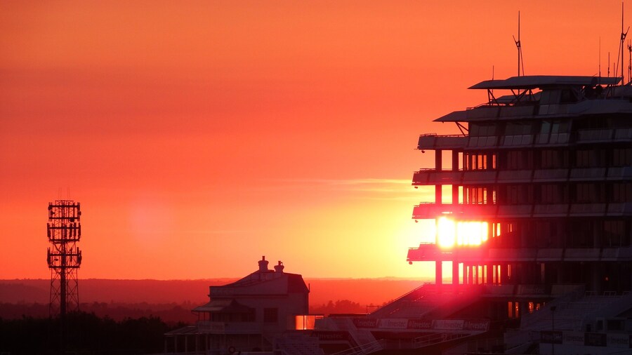 Setting sun shining through the windows of Epsom Racecourse grandstand. The course is open to walkers