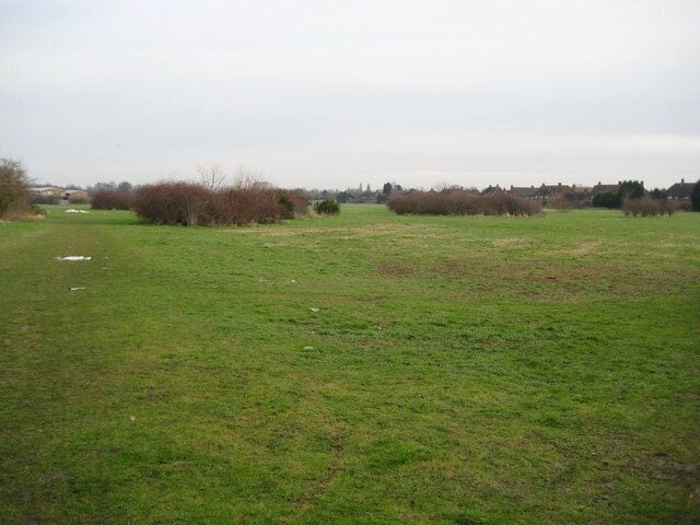 Feltham: Open space north of Uxbridge Road The buildings on the left form part of West Thames College while the houses to the right are on Wigley Road. The last vestiges of the snow of 2 February 2009 can be seen on the ground to the left.