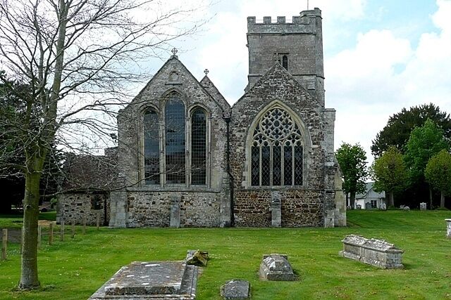 A Gothic-style church with a tall tower and arched windows.