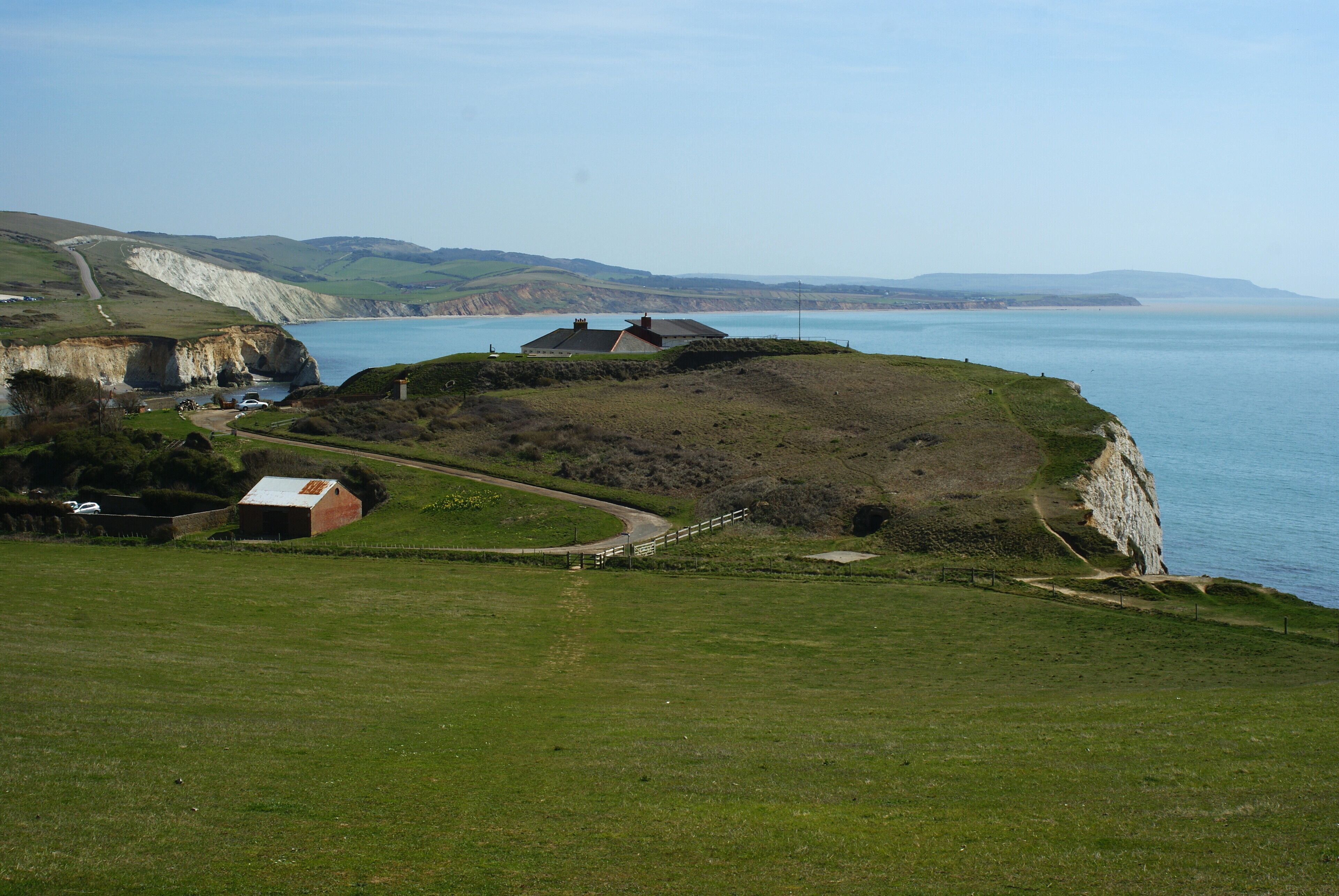 View Towards Fort Redoubt, Freshwater, Isle of Wight Fort Redoubt, in the centre of picture, is now a private residence, overlooking Freshwater Bay. The footpath appears to have been recently re-routed, with two paths crossing this field, meeting at the point at which I was standing.