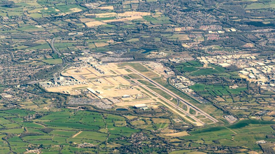An aerial view of a rural landscape with fields, roads, and scattered buildings.