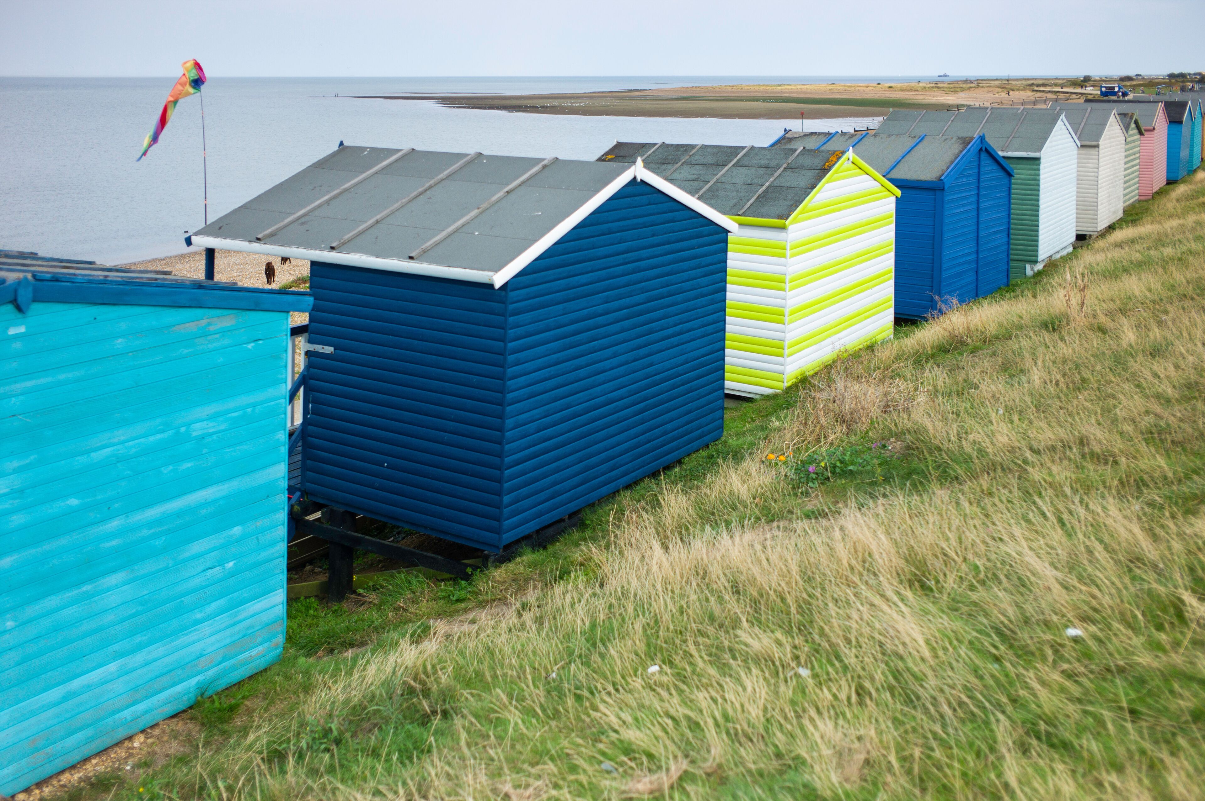 Traditional colorful English beach huts in Whitstable, Kent in the United Kingdom