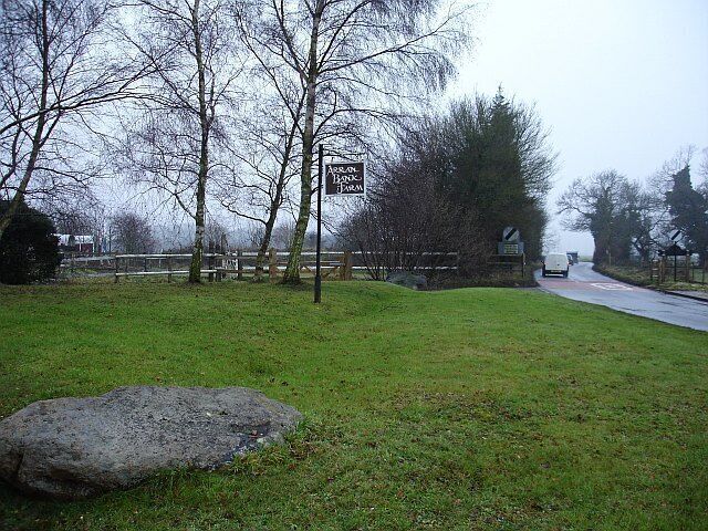 Arran Bank Farm, Dunn Street. Two large sarsen stones guard the entrance to the farm which operates a livery stables. Looking west, the lane moves into the next grid square where the speed restriction ends.