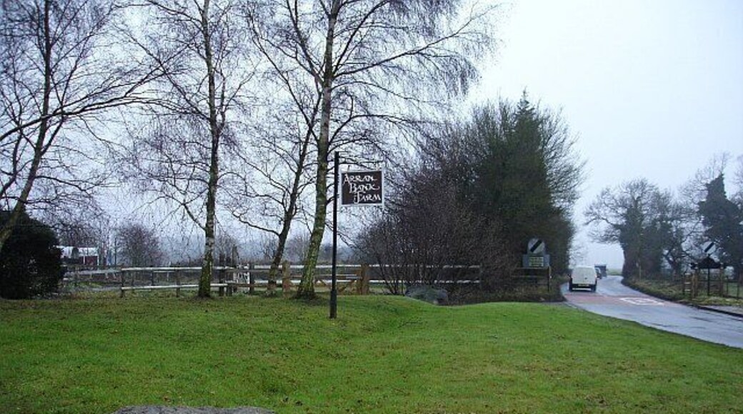 Arran Bank Farm, Dunn Street. Two large sarsen stones guard the entrance to the farm which operates a livery stables. Looking west, the lane moves into the next grid square where the speed restriction ends.
