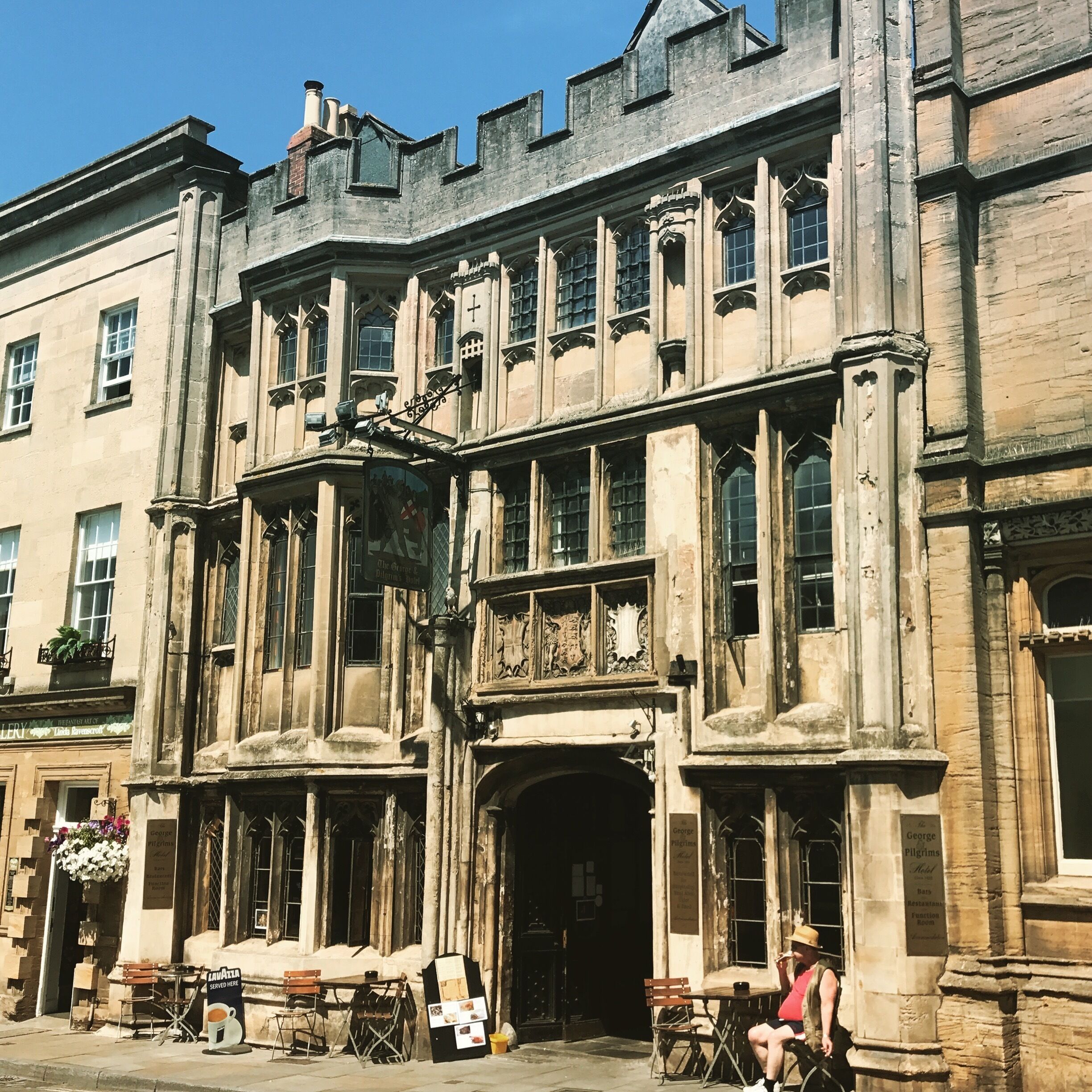 A historic building with large windows and intricate stonework.