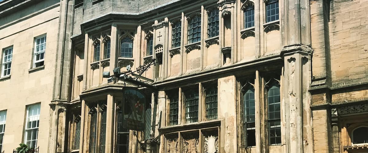 A historic building with large windows and intricate stonework.