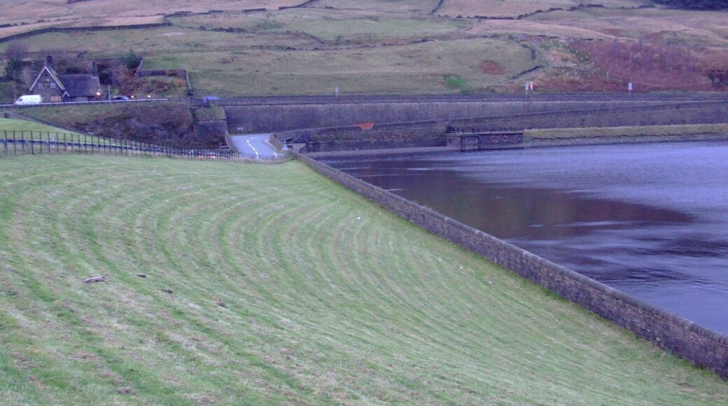 Longdendale in Derbyshire is the valley of the River Etherow. The Longdendale Chain is a series of reservoirs built to provide drinking water forManchester. The Woodhead reservoir is the highest in the chain, and the last to be finished. Taken from the 1992 embankment (6.7m above the 1877 original level) , here is the overflow weir and the B6105 road with the A628 behind. The hill is Hoy Edge. Weather and light difficult. Camera location 53° 29′ 27.52″ N, 1° 52′ 42.24″ W View this and other nearby images on: OpenStreetMap - Google Earth 53.490978; -1.878400