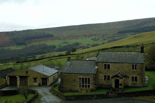 Far Coombes Farm. Stone built farmhouse, you can see the basin shaped rock formation of Coombs Rocks in the background.