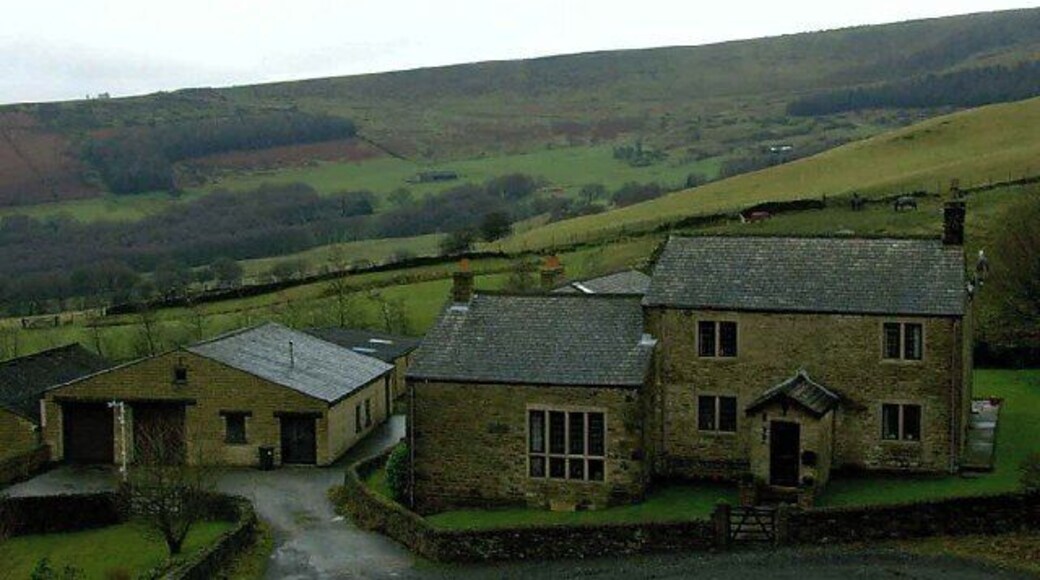 Far Coombes Farm. Stone built farmhouse, you can see the basin shaped rock formation of Coombs Rocks in the background.