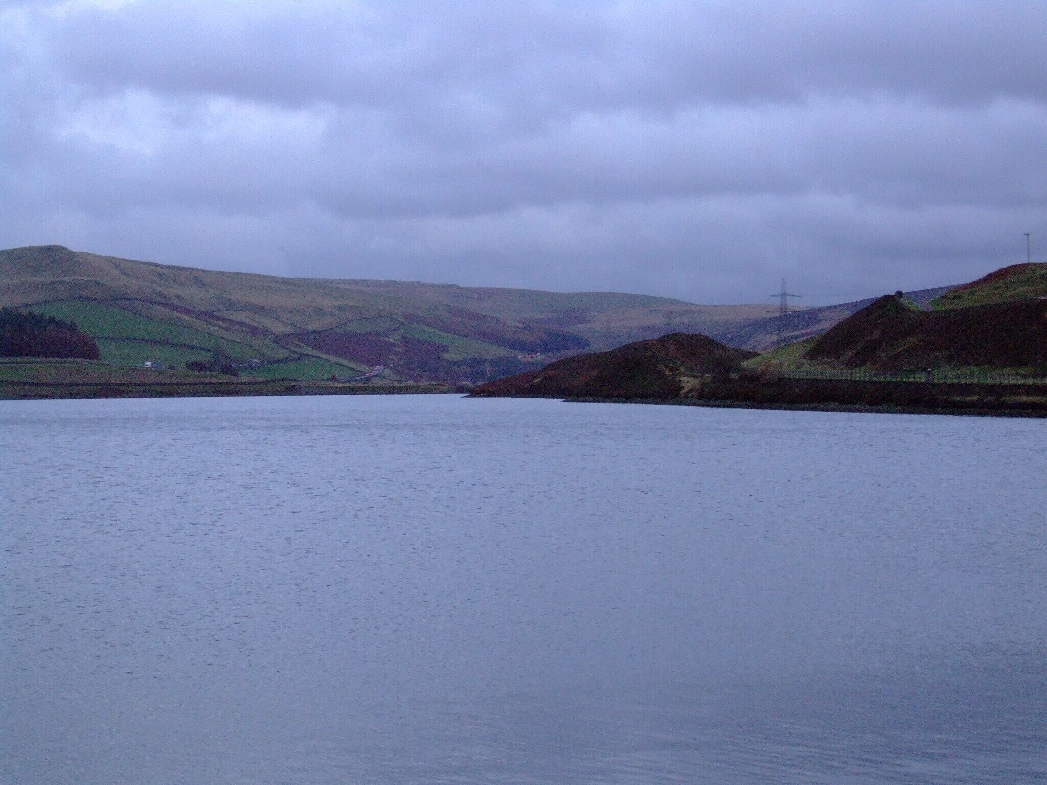 Longdendale in Derbyshire is the valley of the River Etherow. The Longdendale Chain is a series of reservoirs built to provide drinking water forManchester. The Woodhead Reservoir from the Woodhead Embankment. Weather and light difficult. Camera location 53° 29′ 30.7″ N, 1° 52′ 45.6″ W View this and other nearby images on: OpenStreetMap - Google Earth 53.491861; -1.879333