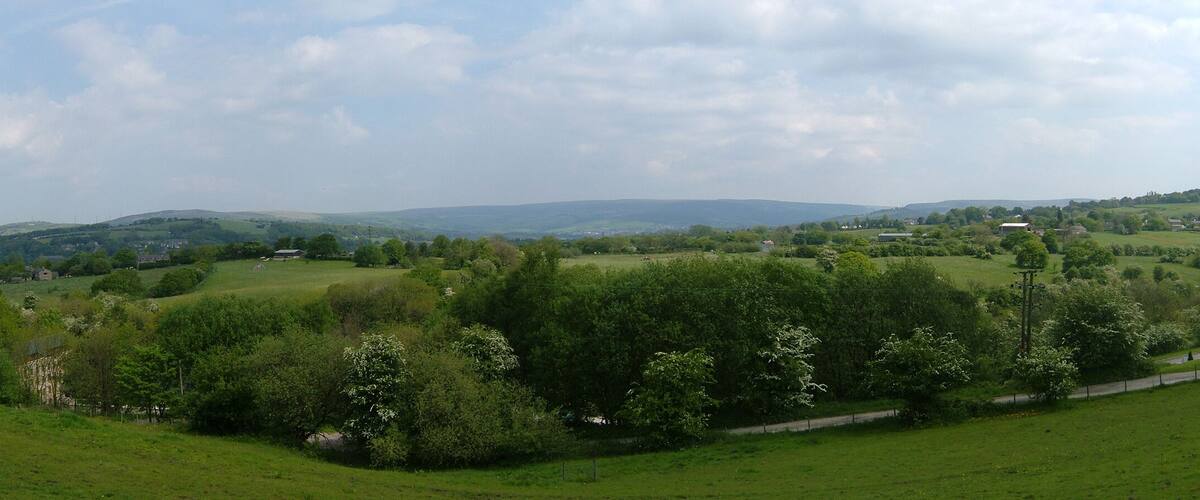 Rolling hills, a road, and scattered buildings.