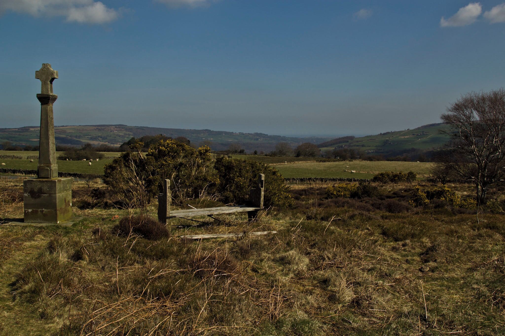 The standing stone was placed there for the monks who would walk the open moors to go or return from Whitby Abbey which is located just a few miles cross country from this stone in the direction this photograph shows.. 