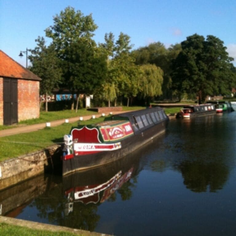 View of the canal at Farncombe, Godalming, Surrey. Iona is a horse-drawn canal boat and you can book a trip along the canal.