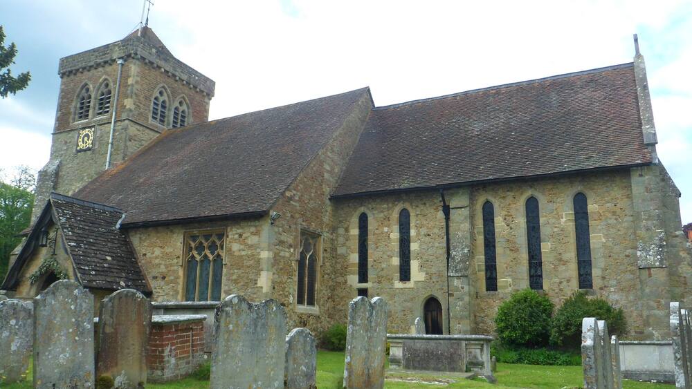 A church with a bell tower and a graveyard.