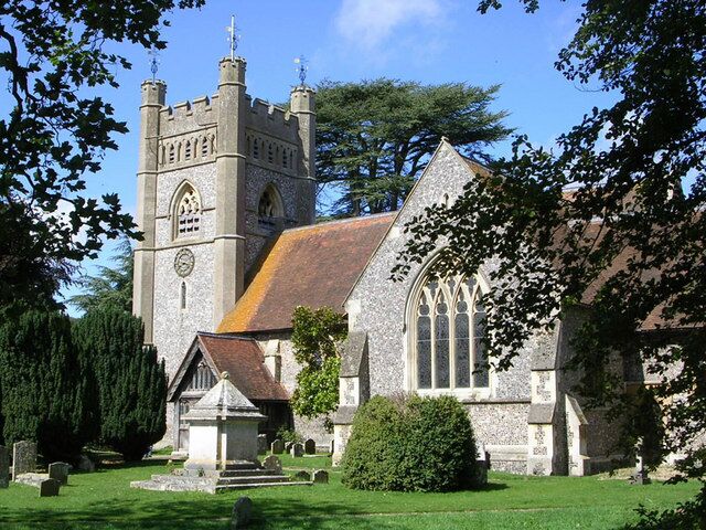 A historic church with a prominent tower and arched windows.
