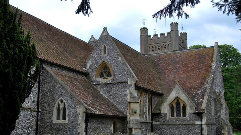 A historic church with a stone facade, pointed arches, and a tower.